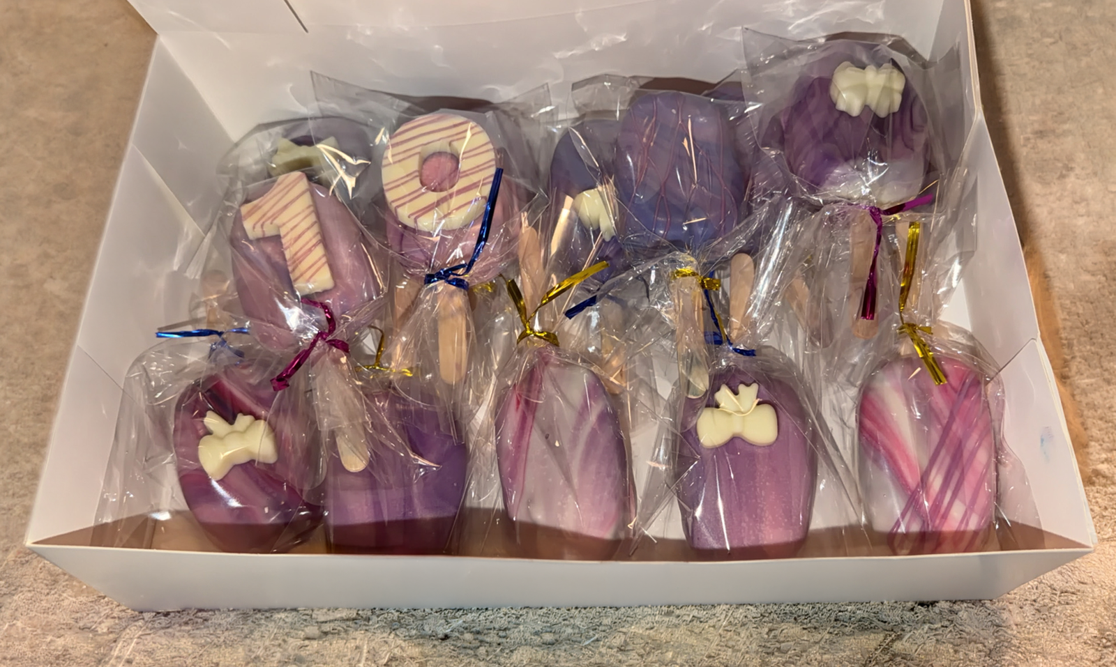 Box of marbled purple cake pops